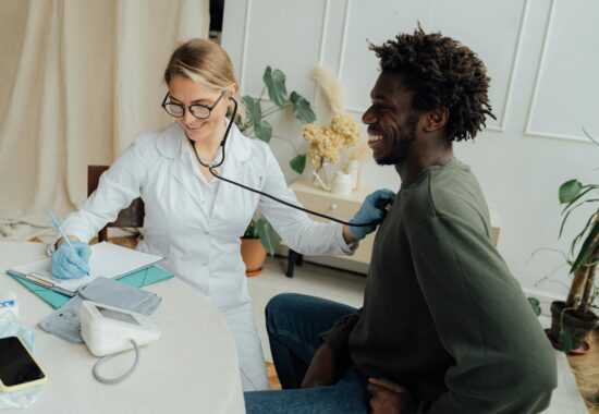 Doctor listening to patient's heart