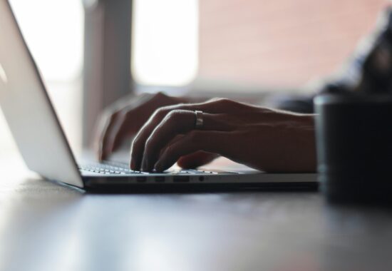 Image of person typing on laptop